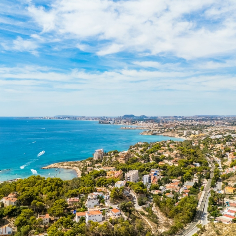 Coastal city with blue ocean and green hills